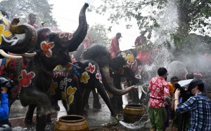 Revellers and elephants splash water at each other during a ceremony to celebrate the Buddhist New Year, locally known as Songkran, in Ayutthaya on April 11, 2019. (Photo by Jewel SAMAD / AFP)